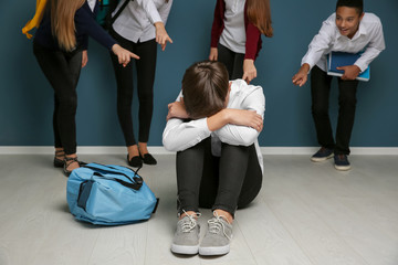 Teens bullying their classmate indoors