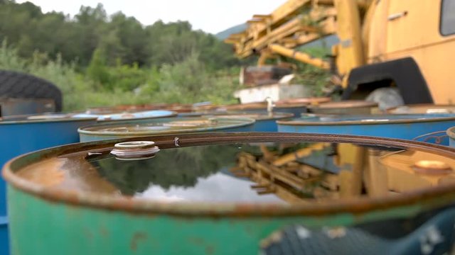 The oil is pouring on ld dirty barrels