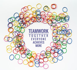 Teamwork concept. group of colorful rubber band on white background with word Teamwork, Together, Everyone, Achieves and More