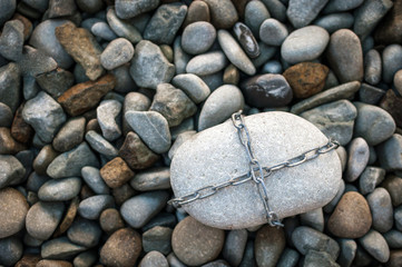 A huge stone tied with a metal chain