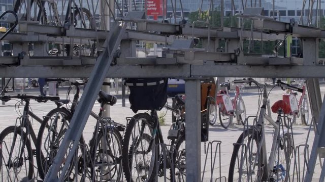Long pan of bikes locked up at bike rack.