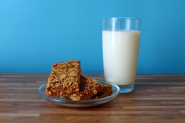 on the table is a glass of milk with cookies