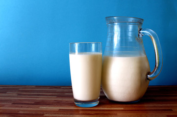 on the table is a jug and a glass of milk