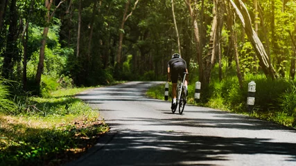 Foto op Plexiglas Cyclist He was cycling uphill climb in the woods. © torwaiphoto