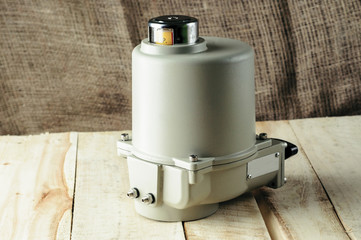 Small electric drive (actuator) gray colour for valves. Isolate . Еxplosion-proof. . Caption: open, closed.