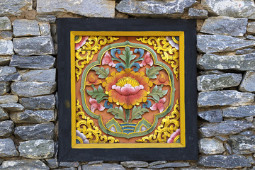 wooden carving with stone background