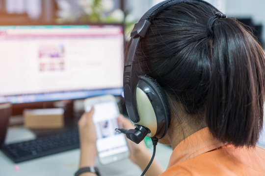 Student online testing exercise concept : Asian girl students learning on smartphone and computer pc for watching video tutorial with headphones in e-school classroom at information center