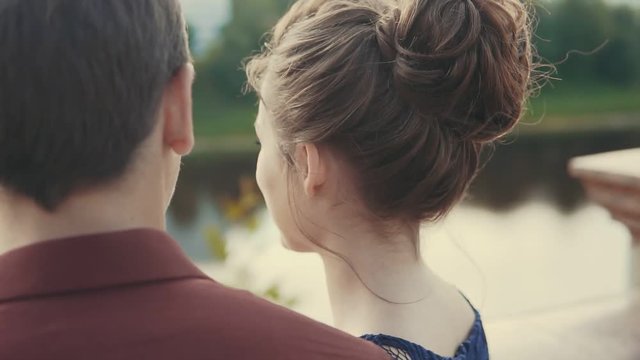 Sensual moment of love at sunset. Happy young couple enjoying intimate moment. Lovely touching noses outdoors. Close up view