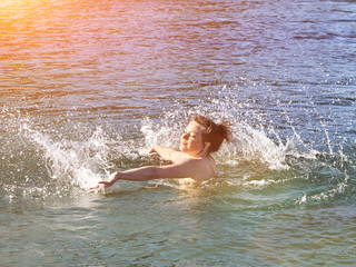 Young caucasian woman having fun and swimming in lake