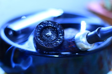 Smoking pipe and ashtray with smoke