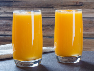 Healthy pumpkin fruit smoothie with  napkin on wooden background