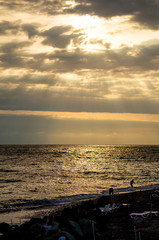 The rays of the sun make their way through the clouds, the seascape