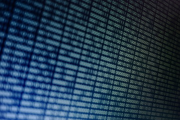 blocks of binary data. Blockchain concept. blue background with computer digital binary code bit number one and zero text. selective focus on the far end of the computer display out of focus in front.