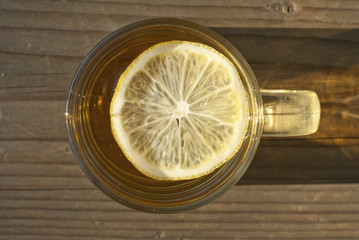 cup of tea with lemon on wooden table