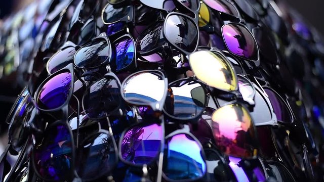 Slow motion dolly shot of colorful sunglasses