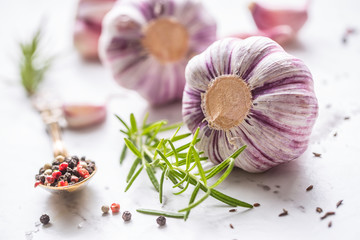 Obraz na płótnie Canvas Garlic Cloves and Bulbs with rosemary salt and pepper.