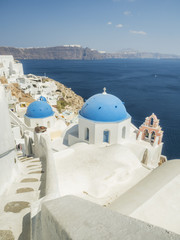 White Church with bells and blue dome at Oia, Santorini, Greek Islands