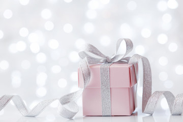 Present or gift box against bokeh background. Holiday greeting card on Birthday or Christmas.