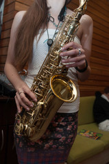 young girl playing saxophone