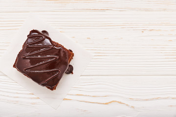 homemade chocolate brownies on white wooden background, top view