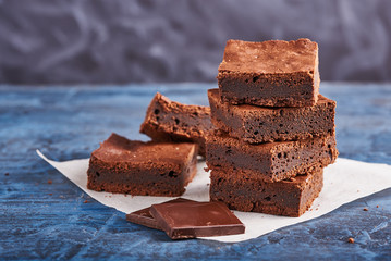 homemade chocolate brownies on dark blue background