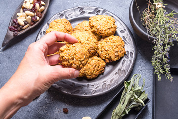 Woman hand taking oat cookies