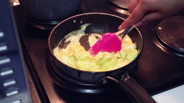 Scrambling eggs in a pan
