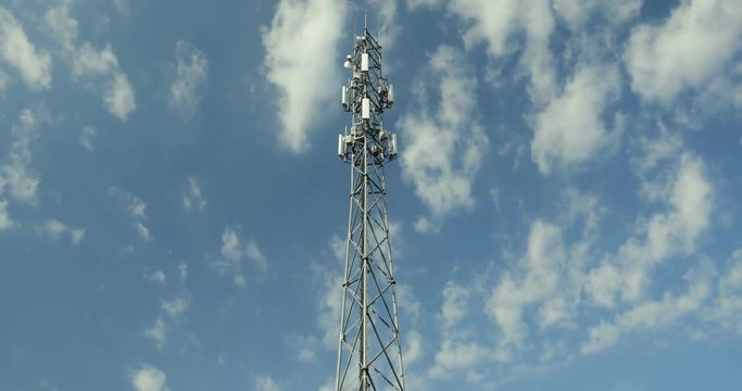 LTE cellular antenna tower against the blue sky - time lapse