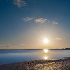 dramatic sunset over a quiet lake
