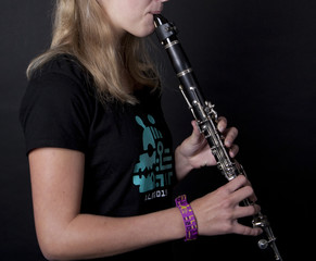 Young woman plays on the clarinet