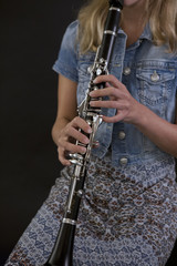 Young woman plays the clarinet