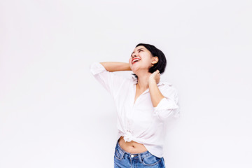 Young beautiful and confident Asian girl with short hair raising hands up with joy and happiness in white isolated background.