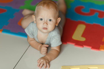 Cute boy 8 months crawling on the floor.
