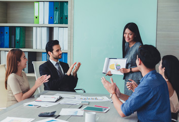 Woman of business discussing ducuments and ideas at meeting.