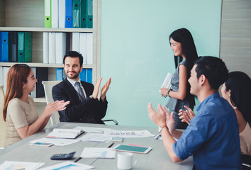 Woman of business discussing ducuments and ideas at meeting.