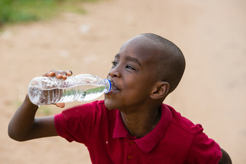 portrait of a child drinking water © vystekimages