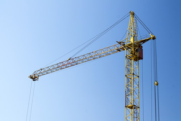 Photo of construction crane against a blue sky background