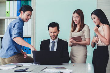 Group of business discussing ducuments and ideas at meeting..