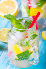 citrus fresh lemonade soda ice mint lemon lime wooden background
