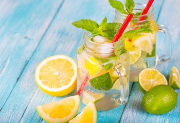 citrus fresh lemonade soda ice mint lemon lime wooden background
