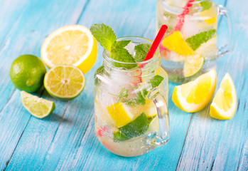citrus fresh lemonade soda ice mint lemon lime wooden background
