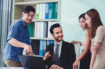 Group of business discussing ducuments and ideas at meeting.