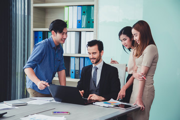 Group of business discussing ducuments and ideas at meeting.