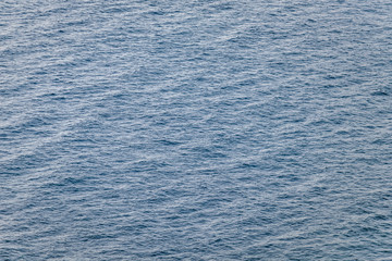 Aerial view of the sea surface. High resolution bird's eye image showing sea waves and currents from above.
