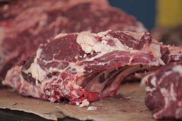 red meat steak detail photography taken on a street african market, on a sunny summer day