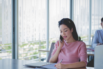 Business concept, Business woman working with bill and phone on wooden table.