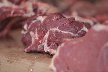 red meat steak detail photography taken on a street african market, on a sunny summer day