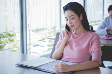 Business concept, Business woman working with bill and phone on wooden table.