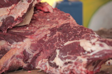 red meat steak detail photography taken on a street african market, on a sunny summer day