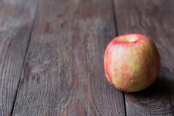 red juicy Apple on wooden background